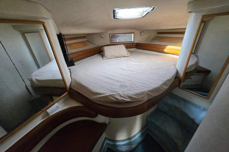 Slide: The Image of 1994 Sea Ray 400 Express Cruiser cabin with bed, mirrors, and skylight. - 7