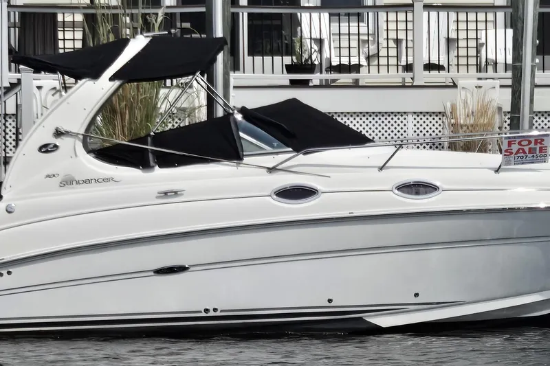 The Image of 2006 Sea Ray 280 Sundancer boat with black canopy, docked and for sale. - 0