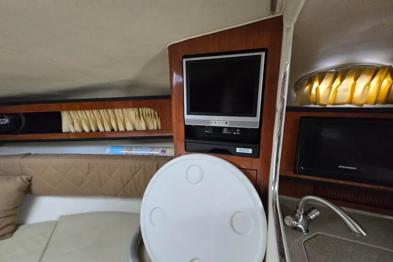 Slide: The Image of Interior of 2006 Sea Ray 280 Sundancer with TV, sink, and cozy seating area. - 10