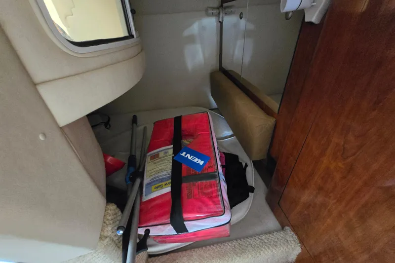 Slide: The Image of Interior of 2006 Sea Ray 280 Sundancer with red life jacket and equipment. - 13