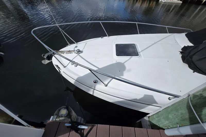 Slide: The Image of 2006 Sea Ray 280 Sundancer docked, showing bow and railing details. - 14