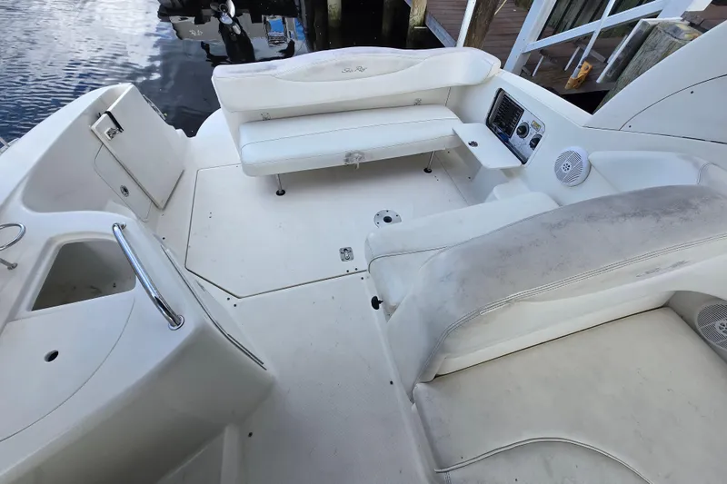 Slide: The Image of 2006 Sea Ray 280 Sundancer boat interior with white seating and control panel. - 5