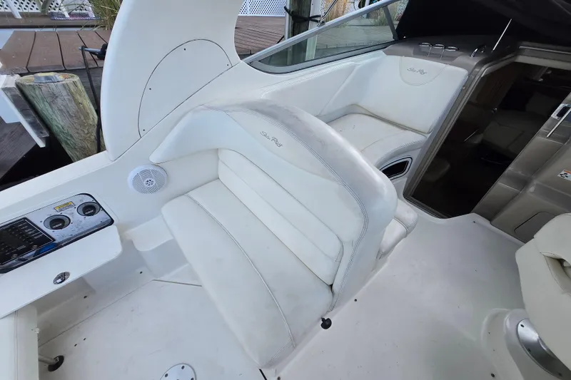 Slide: The Image of 2006 Sea Ray 280 Sundancer interior with white seating and control panel. - 6