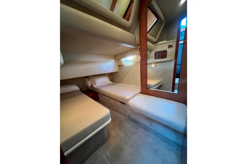 Slide: The Image of Interior cabin of 2000 Sea Ray 400 Sedan Bridge with twin beds and mirror. - 125