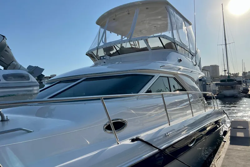 Slide: The Image of 2000 Sea Ray 400 Sedan Bridge yacht docked at marina under clear sky. - 16