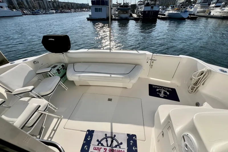 Slide: The Image of Spacious deck of 2000 Sea Ray 400 Sedan Bridge yacht in marina setting. - 19