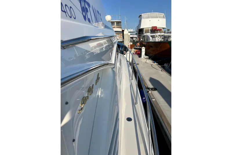 Slide: The Image of 2000 Sea Ray 400 Sedan Bridge yacht docked at marina, side view. - 34