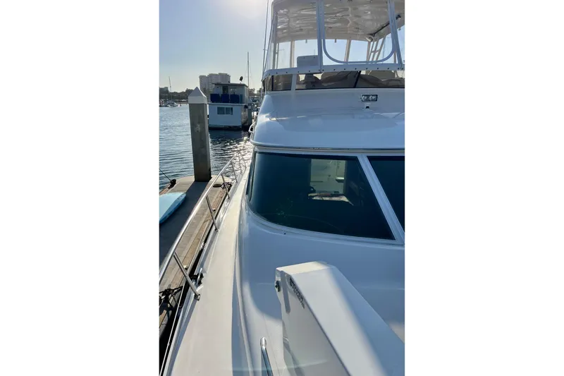 Slide: The Image of 2000 Sea Ray 400 Sedan Bridge yacht docked at marina, sunny day. - 37