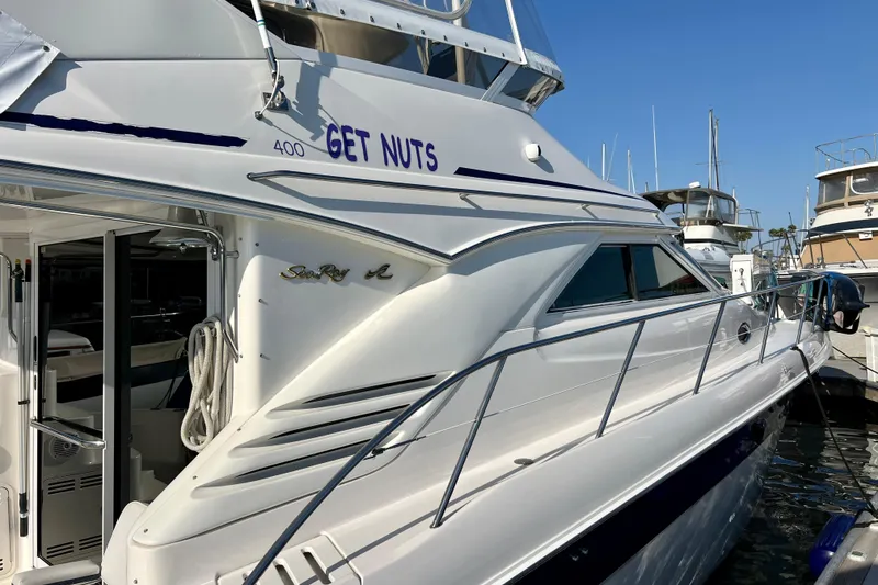 Slide: The Image of 2000 Sea Ray 400 Sedan Bridge yacht docked at marina, side view. - 5