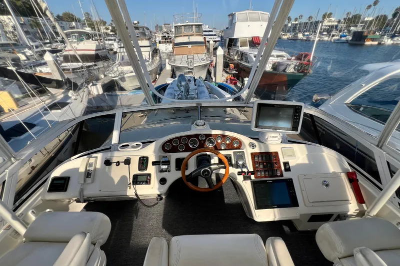 Slide: The Image of Cockpit view of 2000 Sea Ray 400 Sedan Bridge yacht in marina. - 55