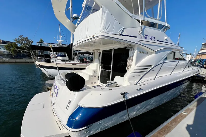 Slide: The Image of 2000 Sea Ray 400 Sedan Bridge yacht docked at marina, rear view. - 6