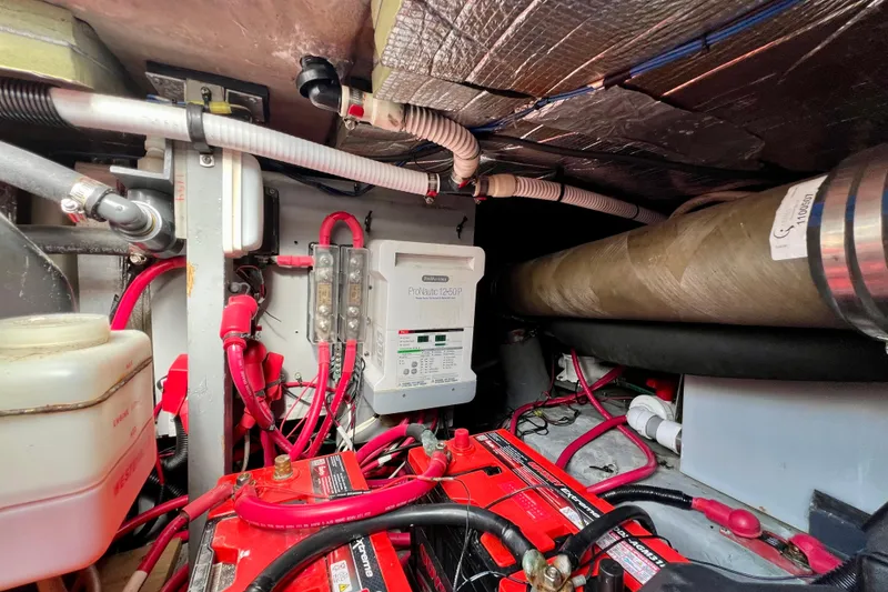 Slide: The Image of Engine room of 2000 Sea Ray 400 Sedan Bridge with batteries and wiring. - 66
