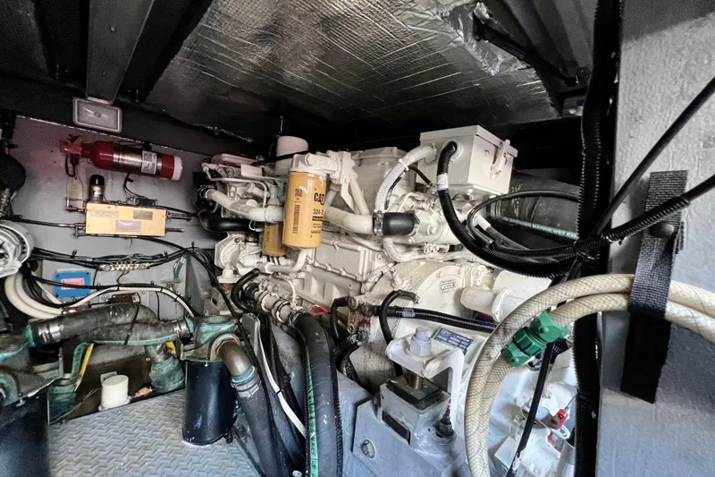 Slide: The Image of Engine room of a 2000 Sea Ray 400 Sedan Bridge with visible machinery and components. - 70