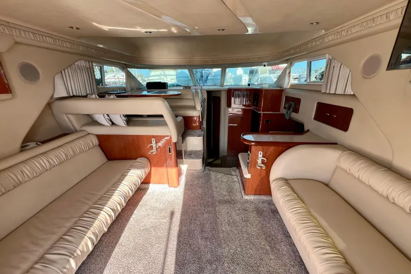 Slide: The Image of Interior of 2000 Sea Ray 400 Sedan Bridge yacht with beige seating and wood accents. - 74