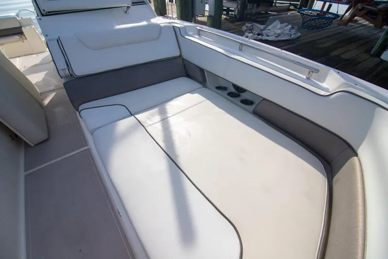 Slide: The Image of 2016 World Cat 320 DC boat interior with cushioned seating and cup holders. - 13