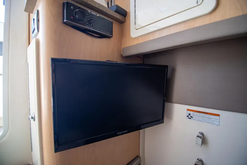 Slide: The Image of 2016 World Cat 320 DC interior with mounted TV and audio system. - 18