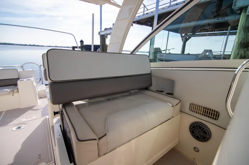Slide: The Image of 2016 World Cat 320 DC boat interior with cushioned seating and cup holders. - 20