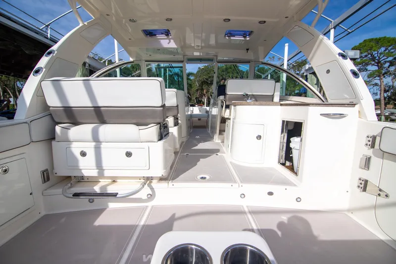 Slide: The Image of 2016 World Cat 320 DC boat interior with seating and storage compartments. - 23