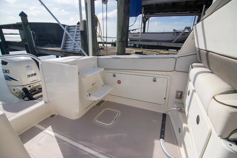 Slide: The Image of 2016 World Cat 320 DC boat interior with Suzuki 300 engine, docked at marina. - 30