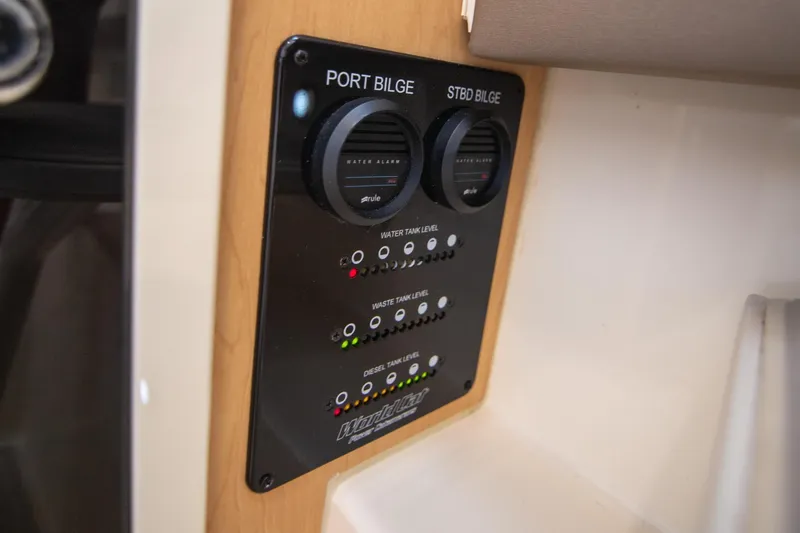Slide: The Image of Control panel on 2016 World Cat 320 DC boat, showing bilge and tank levels. - 34