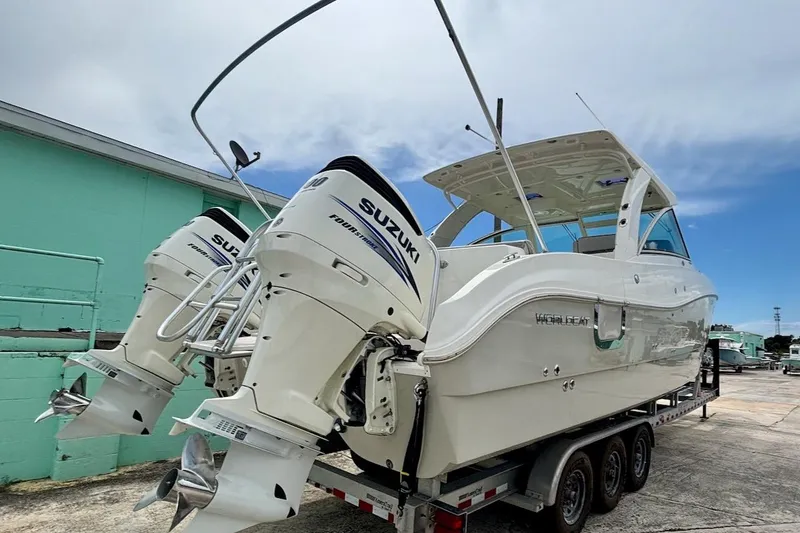 Slide: The Image of 2016 World Cat 320 DC boat with twin Suzuki outboard engines on a trailer. - 36