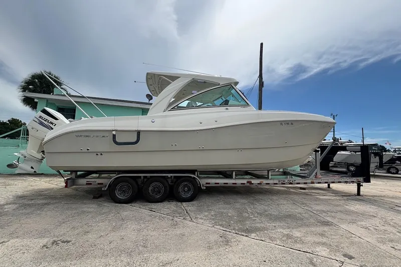 Slide: The Image of 2016 World Cat 320 DC boat on trailer, side view, with Suzuki engines. - 37