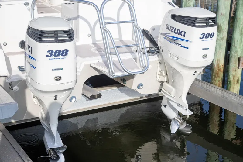 Slide: The Image of 2016 World Cat 320 DC with dual Suzuki 300 outboard engines at dock. - 5