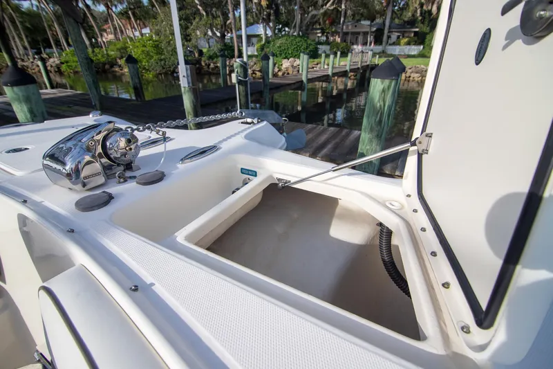 Slide: The Image of 2016 World Cat 320 DC boat deck with open storage compartment and anchor chain. - 8