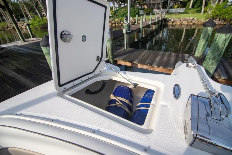 Slide: The Image of Open storage compartment on 2016 World Cat 320 DC boat, dockside view. - 9