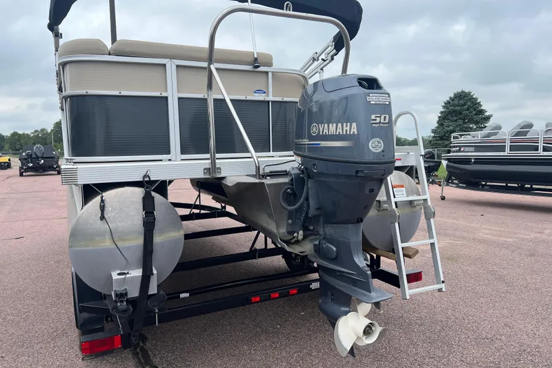 Slide: The Image of 2015 Bennington 22 SLX pontoon boat with Yamaha 50 HP outboard motor on trailer. - 2