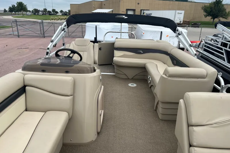Slide: The Image of 2015 Bennington 22 SLX pontoon boat with beige seating and black canopy. - 3