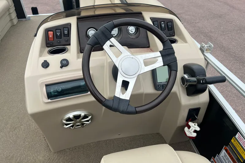 Slide: The Image of Steering console of a 2015 Bennington 22 SLX boat with controls and gauges. - 4