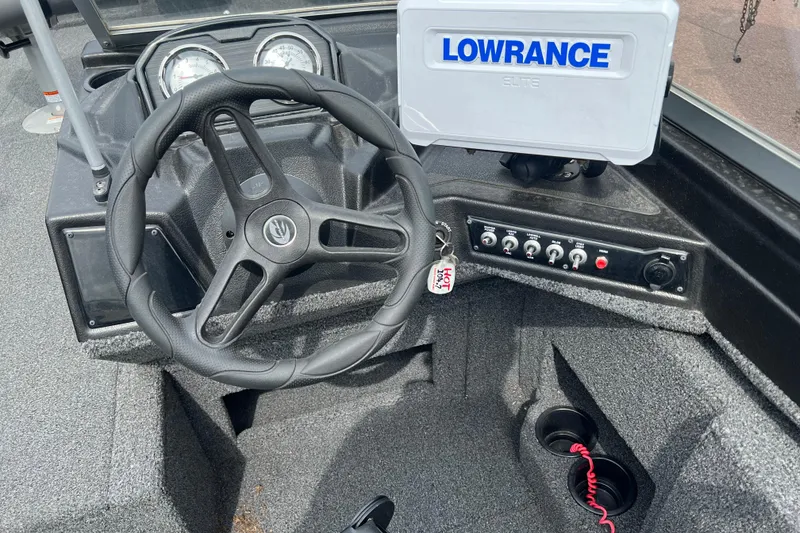 Slide: The Image of 2022 Crestliner 1850 Fish Hawk dashboard with steering wheel and Lowrance Elite display. - 2