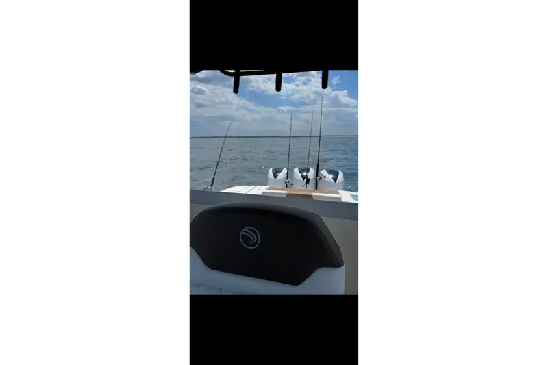 Slide: The Image of 2017 Edgewater 368CC boat with fishing rods on open water. - 14