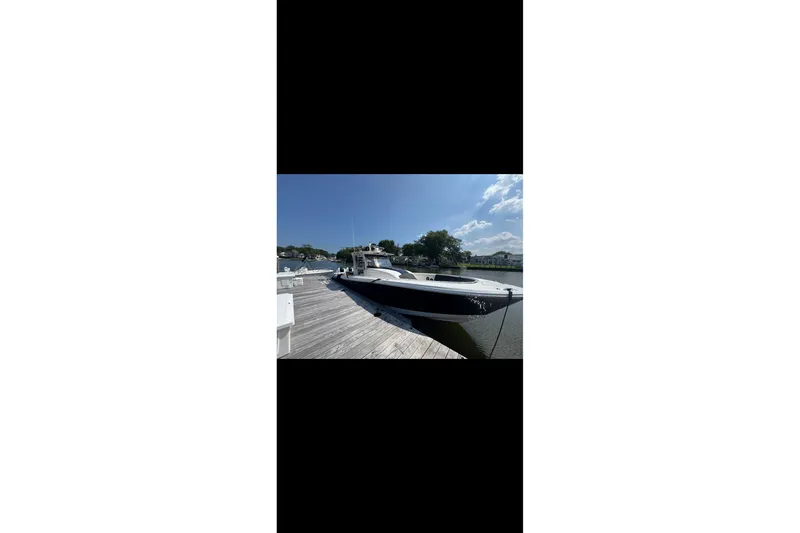 Slide: The Image of 2017 Edgewater 368CC boat docked on a sunny day, clear blue sky. - 18