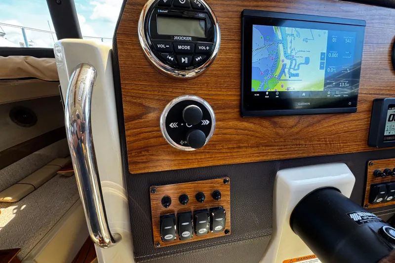 Slide: The Image of Dashboard of 2023 Ranger Tugs R-23 with navigation screen and controls. - 8