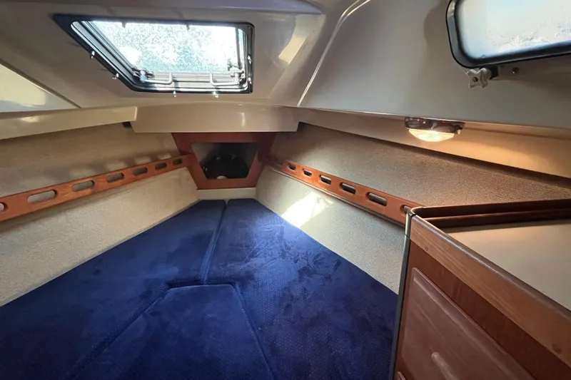 Slide: The Image of Interior cabin of 1985 O'Day 35 sailboat with blue carpet and wood accents. - 12