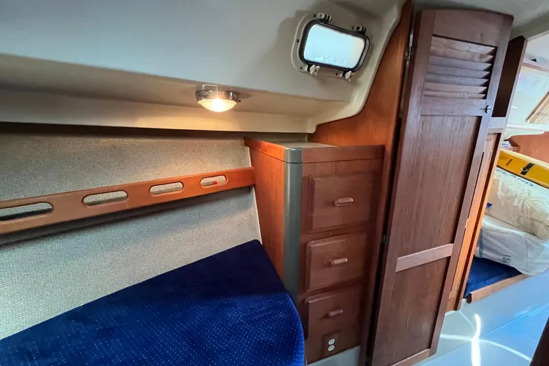 Slide: The Image of Interior of 1985 O'Day 35 sailboat with wooden cabinets and cozy lighting. - 13