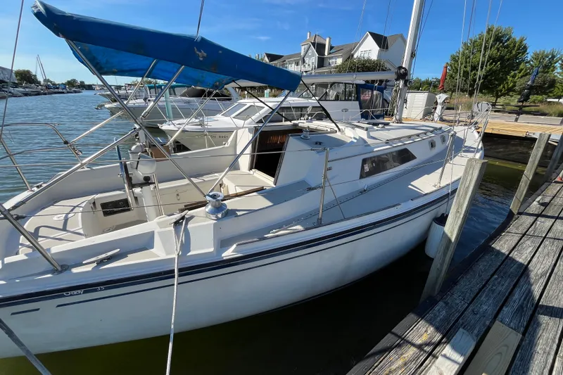 Slide: The Image of 1985 O'Day 35 sailboat docked at marina under blue sky. - 2