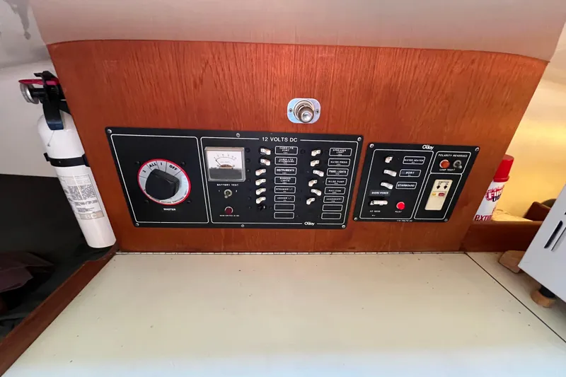 Slide: The Image of Control panel of a 1985 O'Day 35 sailboat with switches and fire extinguisher. - 7