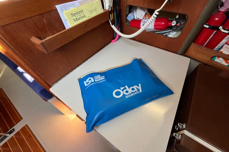 Slide: The Image of Blue O'Day sailboats pouch on a table inside a 1985 O'Day 35 yacht cabin. - 8