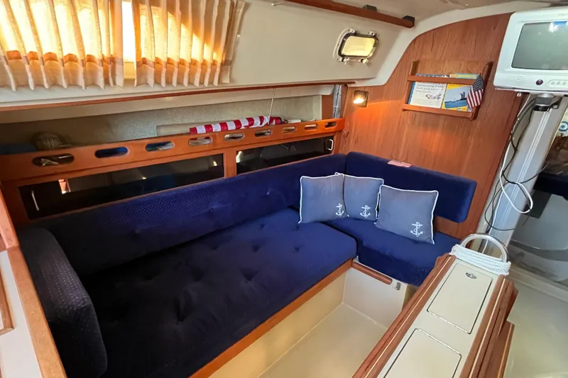 Slide: The Image of Interior of 1985 O'Day 35 sailboat with blue seating and nautical decor. - 9
