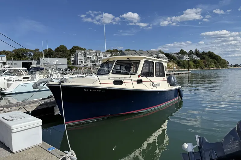Slide: The Image of 2020 Eastern Islander 270 boat docked in a marina under a clear blue sky. - 1
