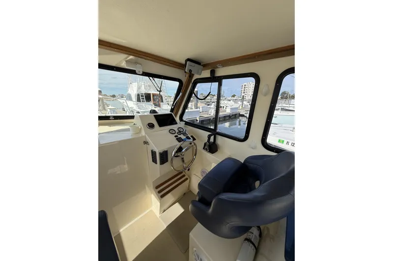 Slide: The Image of Interior view of 2020 Eastern Islander 270 boat cockpit with steering wheel and controls. - 10