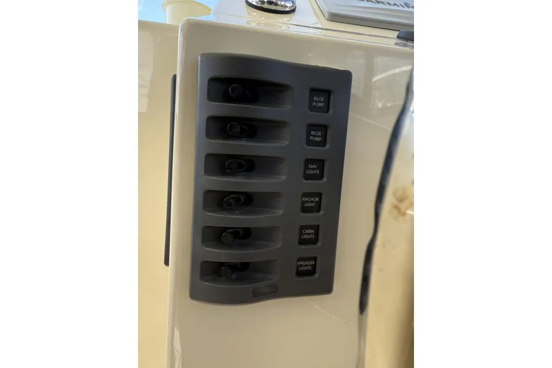 Slide: The Image of Control panel on 2020 Eastern Islander 270 boat with labeled switches. - 13
