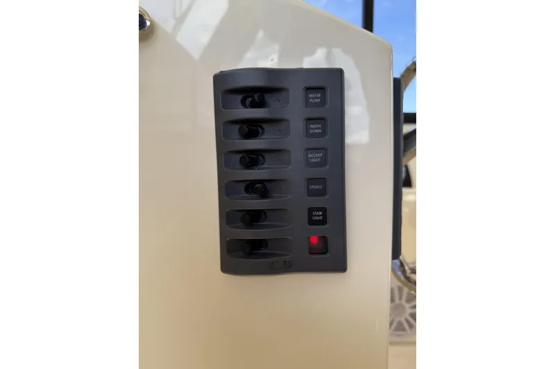 Slide: The Image of Control panel of 2020 Eastern Islander 270 boat with labeled switches. - 15