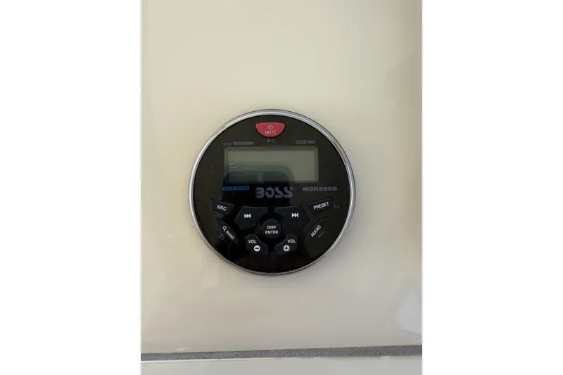 Slide: The Image of 2020 Eastern Islander 270 boat stereo system, Boss MGR350B, mounted on beige panel. - 16
