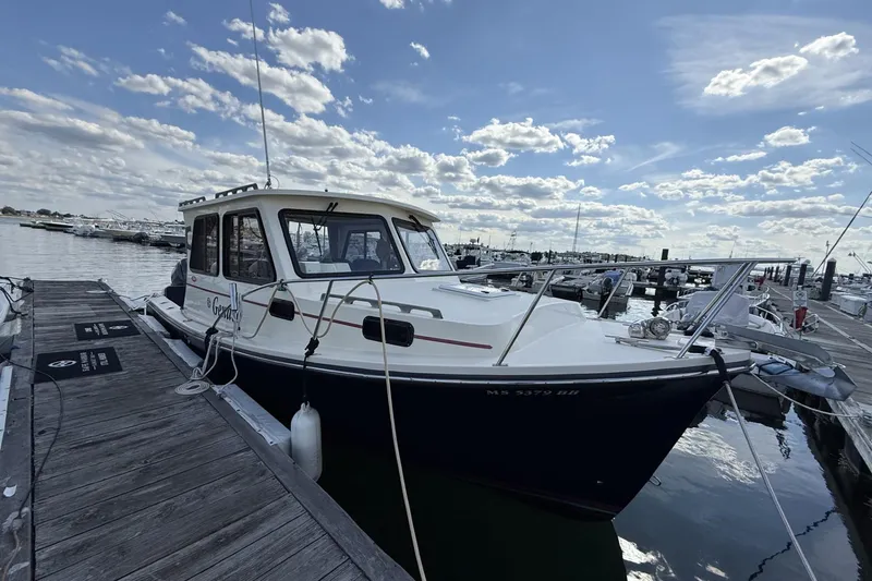 Slide: The Image of 2020 Eastern Islander 270 boat docked at marina under a partly cloudy sky. - 2