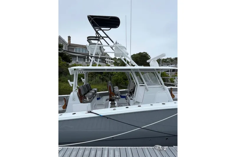 Slide: The Image of 2025 Freeman 42 LR boat docked, featuring sleek design and modern seating. - 20