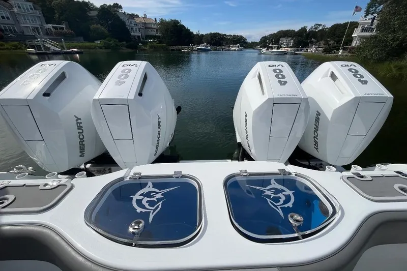 Slide: The Image of Freeman 42 LR 2025 boat with four Mercury 400 outboard engines on a scenic waterway. - 27